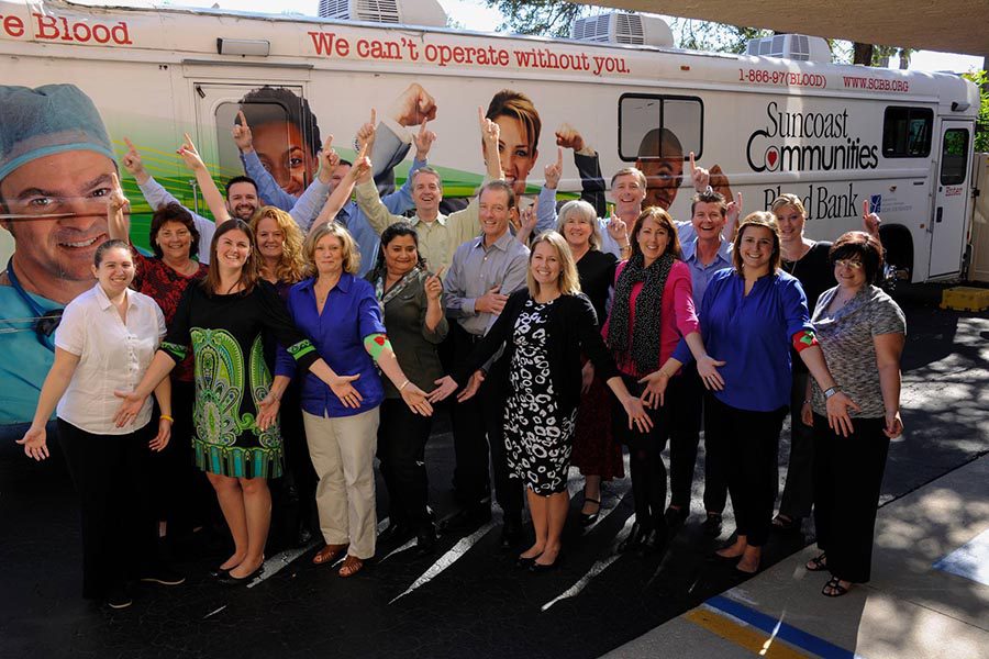Community Involvement - Atlas Insurance Team Photo in Front of Blood Drive Bus